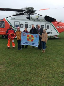 Deputy Mayor of the County of Cork, Cllr Kevin O’Keeffe joins Caroline Casey, Cork County Council and Rescue 117 Coast Guard Helicopter Crew to present the Water Safety Awareness Flag to Castlelyons National School students together with their Principal, Neilus de Roiste.
