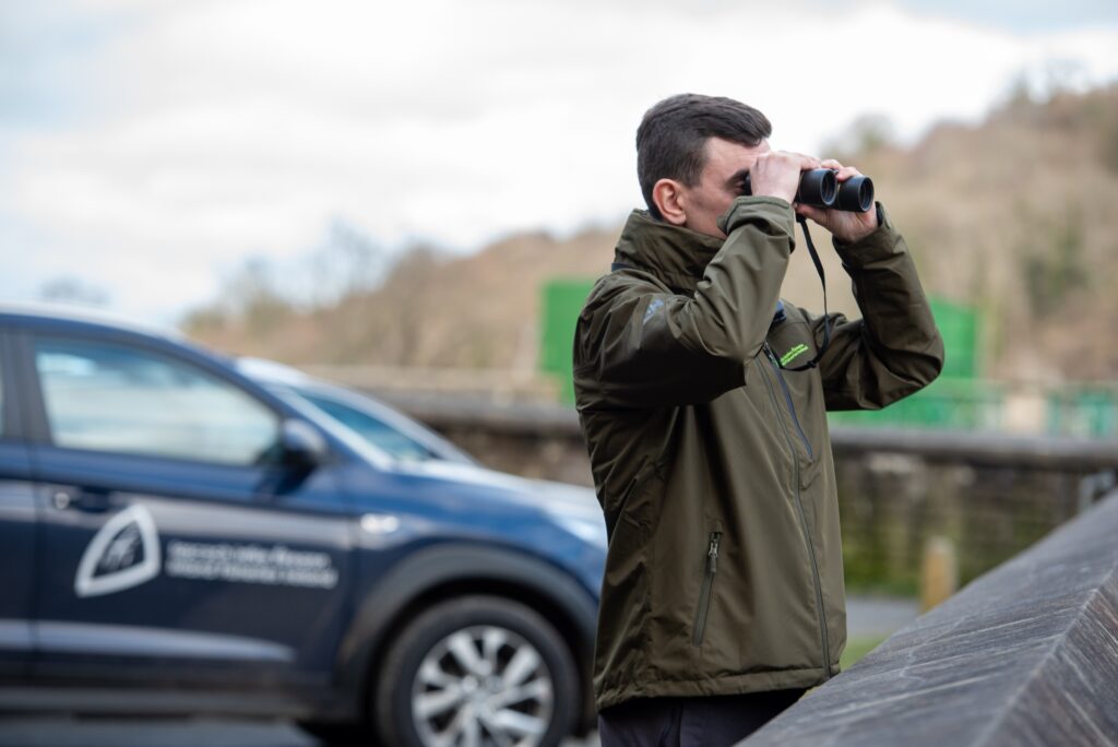 Fisheries Officer looking out across a waterbody